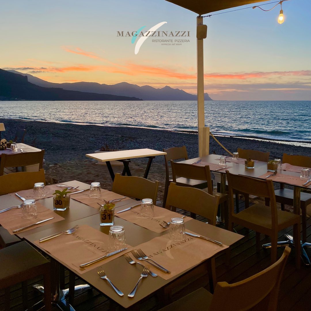 Tavolo di ristorante in riva al mare al tramonto. Ristorante Magazzinazzi ad Alcamo Marina. Dove mangiare ad Alcamo Marina. Migliori Ristoranti ad Alcamo Marina